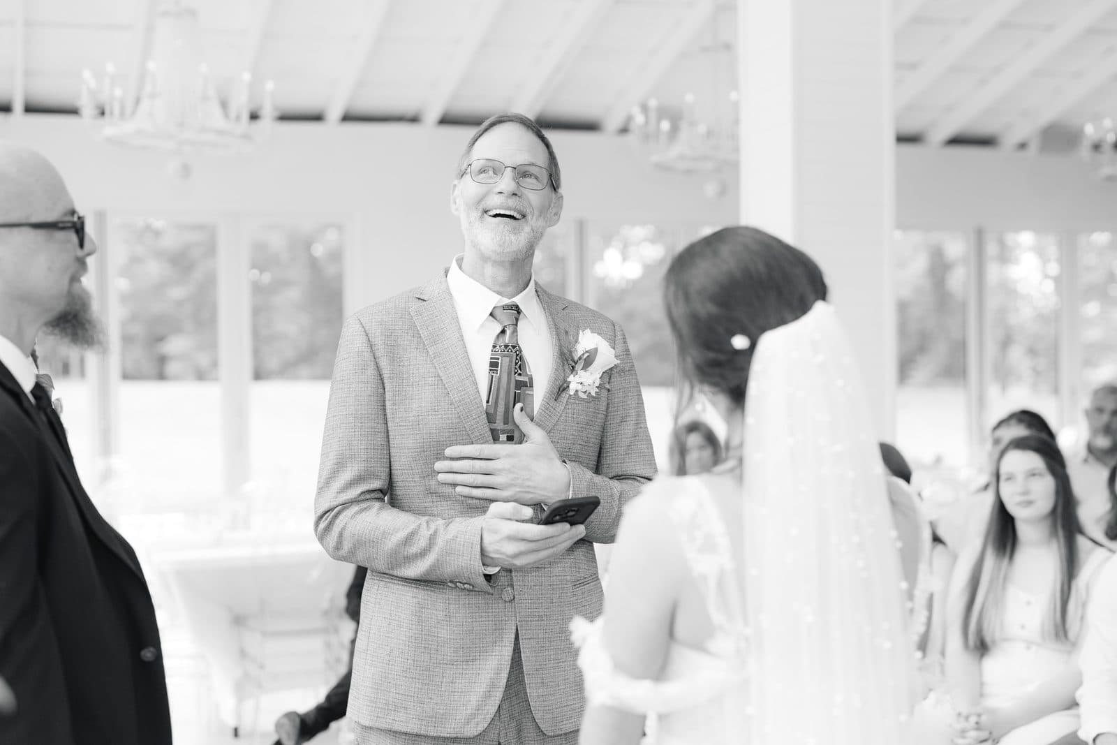 A father laughing through tears mid-ceremony